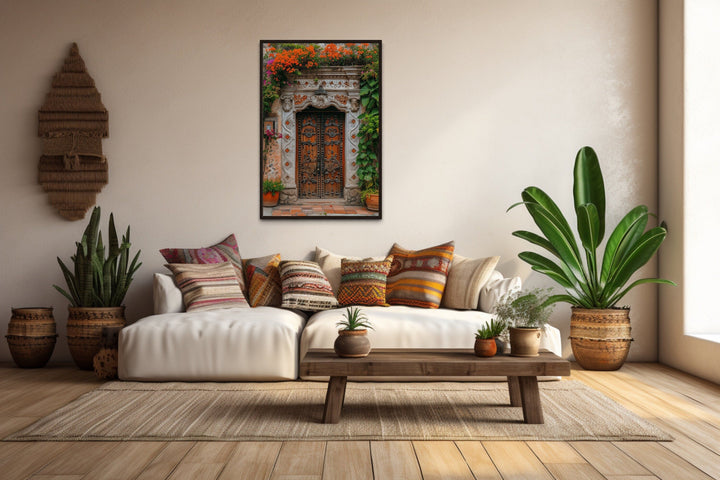 Framed canvas wall art of a colorful Mexican door with orange flowers in a rustic living room.