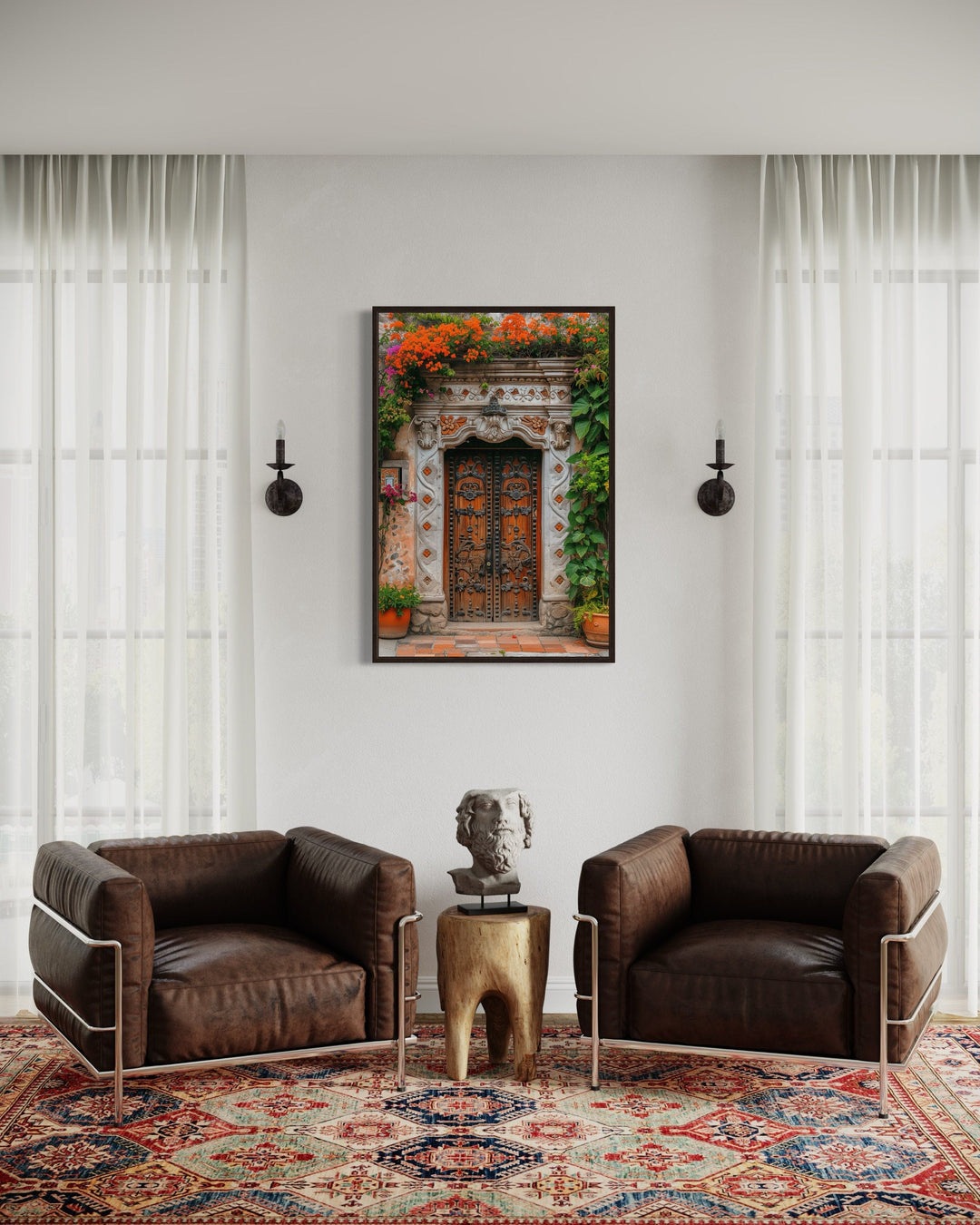 Framed canvas wall art of a colorful Mexican door with flowers above two brown leather armchairs.
