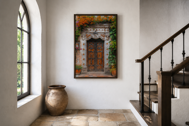 Framed canvas wall art of a rustic Mexican door with orange flowers in a white hallway.