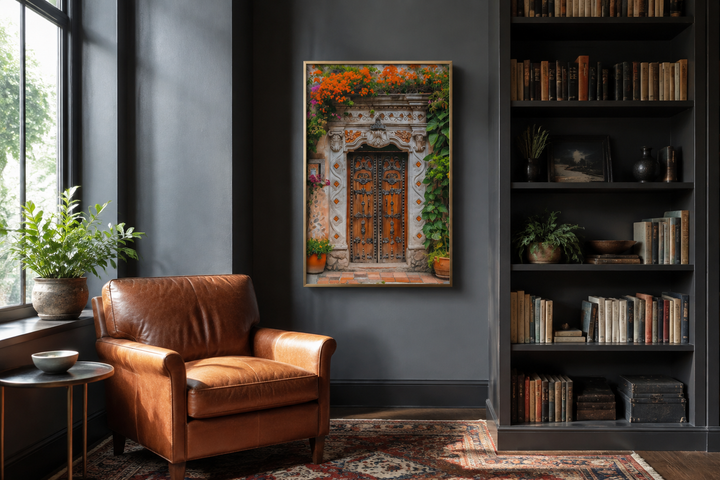 Colorful Mexican door painting framed canvas wall art in a dark gray room with a leather chair.