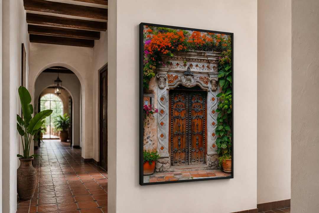 Framed canvas wall art of a rustic Mexican door with orange flowers in a Mediterranean hallway.