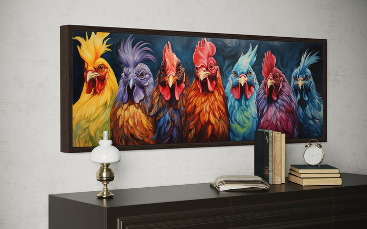 Colorful roosters and chickens horizontal farmhouse wall art in a dark frame above a sideboard.