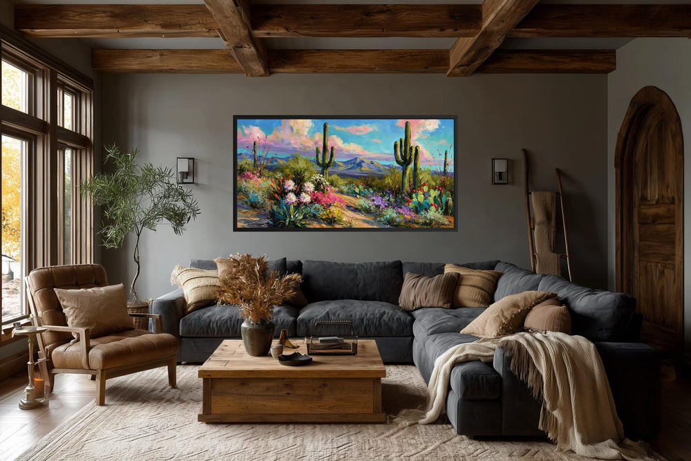 Colorful saguaro cactus and wildflower desert canvas wall art in a rustic living room.