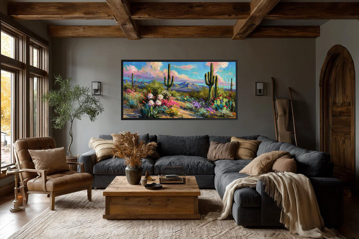 Colorful saguaro cactus and wildflower desert canvas wall art in a rustic living room.