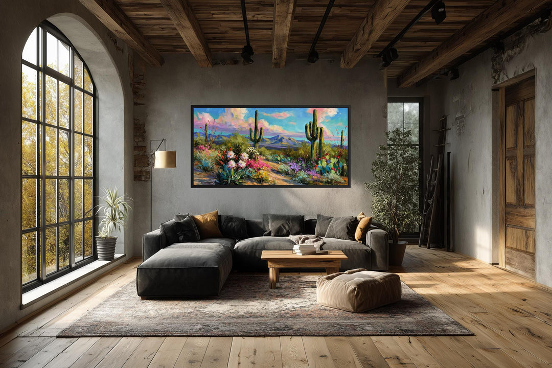 Colorful saguaro cactus and wildflower desert canvas wall art in a modern living room.