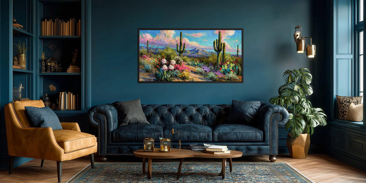 Colorful saguaro cactus and wildflower desert canvas wall art in a dark blue living room.