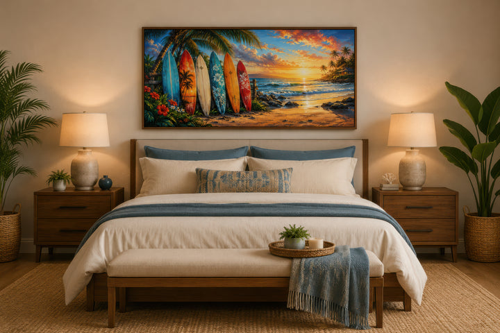 Colorful surfboards on a sunset beach framed canvas wall art hanging above a bed in a bedroom.