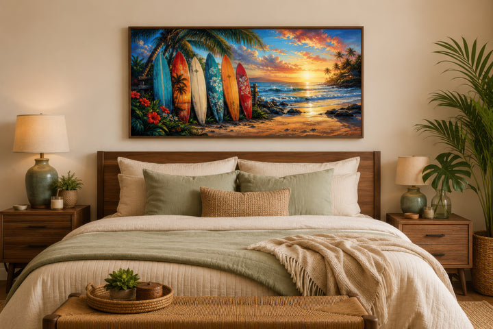 Colorful surfboards on a beach at sunset framed canvas wall art hanging above a bed.