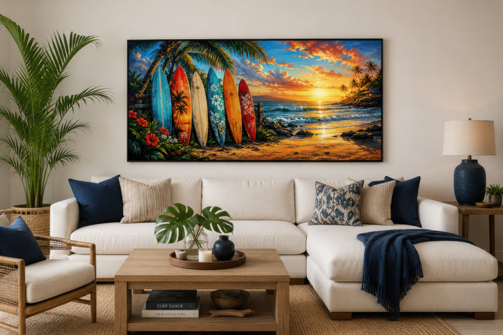 Colorful surfboards on a beach at sunset framed canvas wall art above a white sectional sofa.