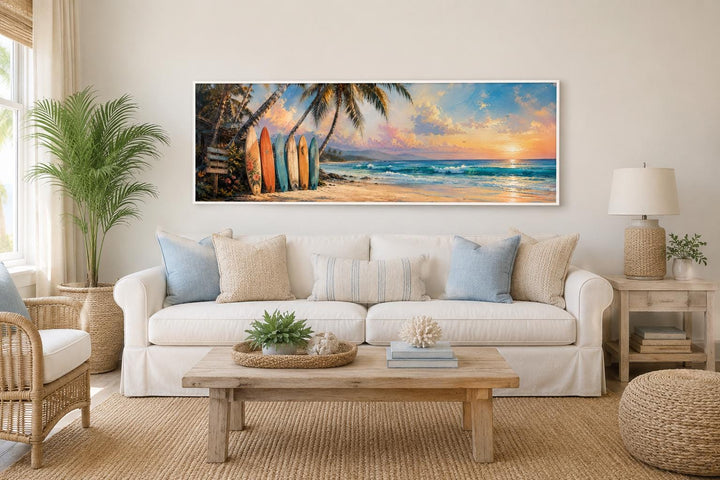 Colorful surfboards on a tropical beach at sunset horizontal canvas wall art above a white sofa.