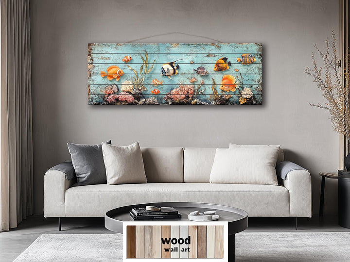 A long narrow wood wall art piece featuring colorful tropical fish and coral on a blue background.