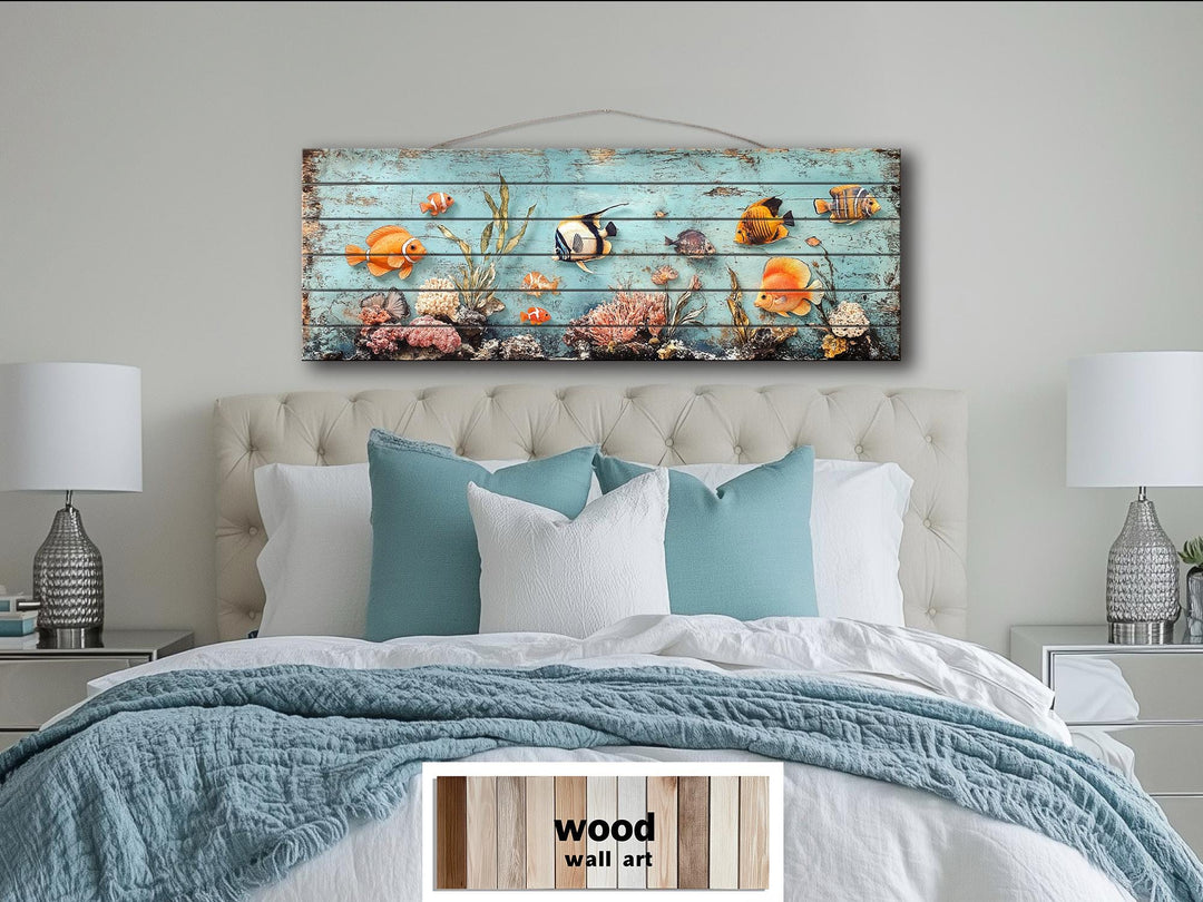 A long narrow wood wall art piece featuring colorful tropical fish and coral on a distressed blue.