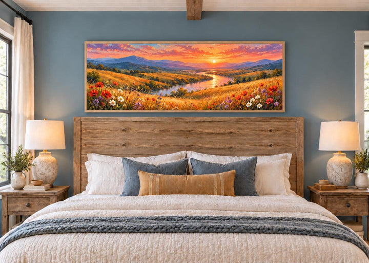 Colorful Wildflower Meadow and River Sunset panoramic canvas wall art above a wooden bed frame.