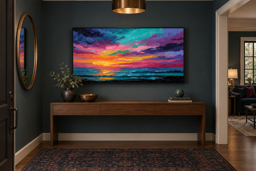 Colorful abstract ocean sunset framed canvas wall art above a wooden console table in a dark room.