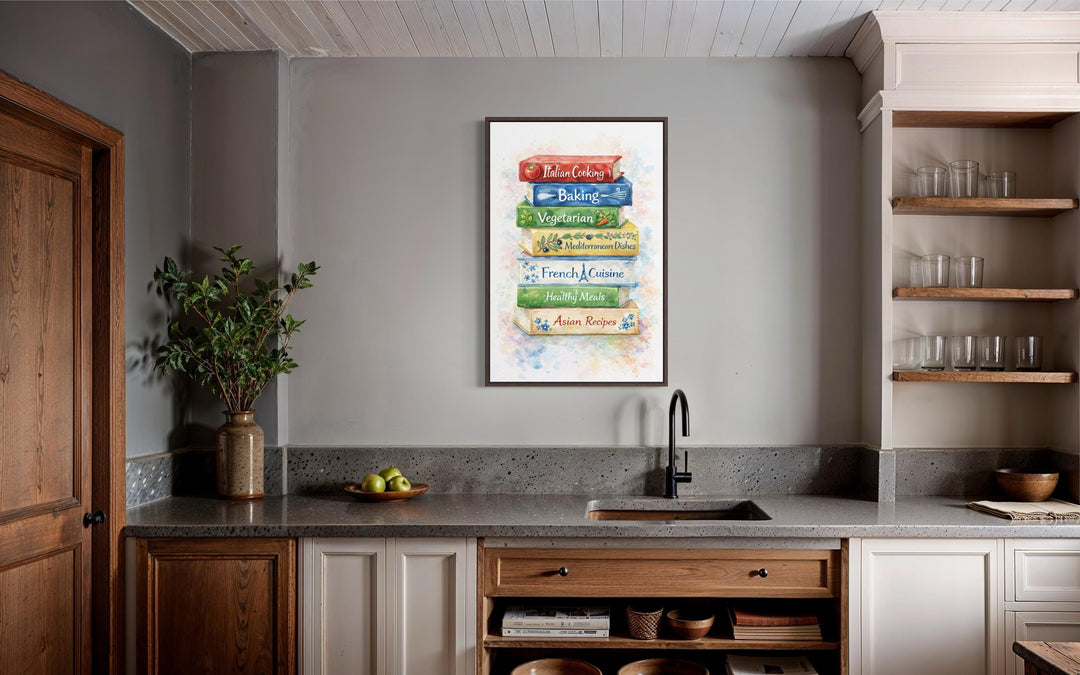 A vertical canvas print of stacked colorful cookbooks hangs in a rustic farmhouse kitchen.