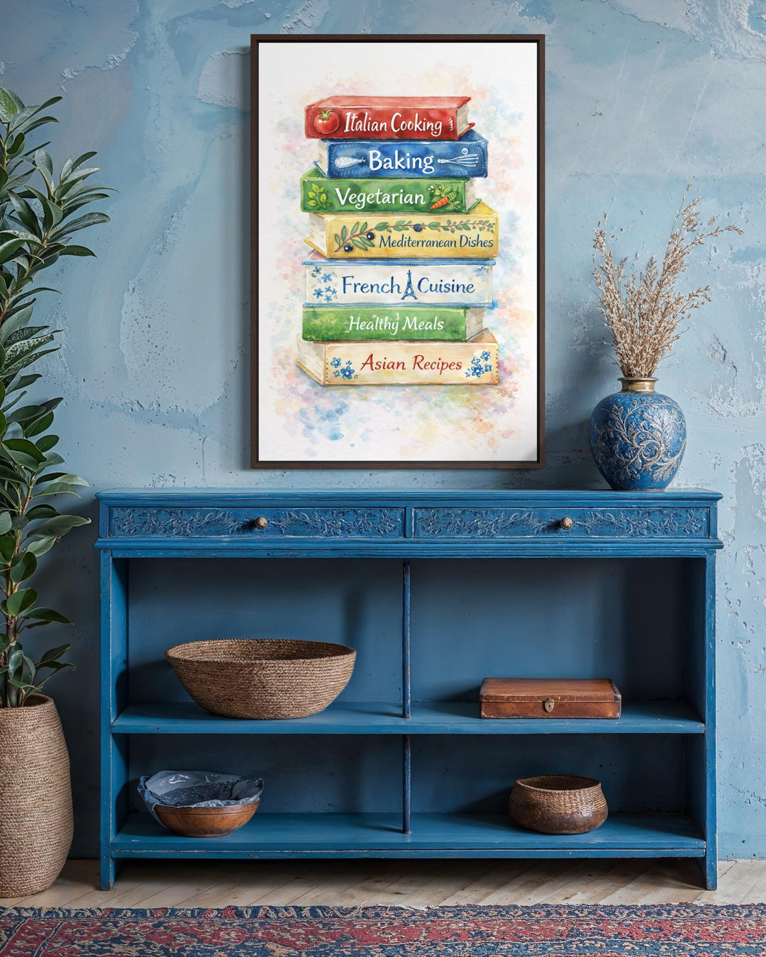 A framed canvas print of stacked colorful cookbooks hangs above a blue wooden console table.