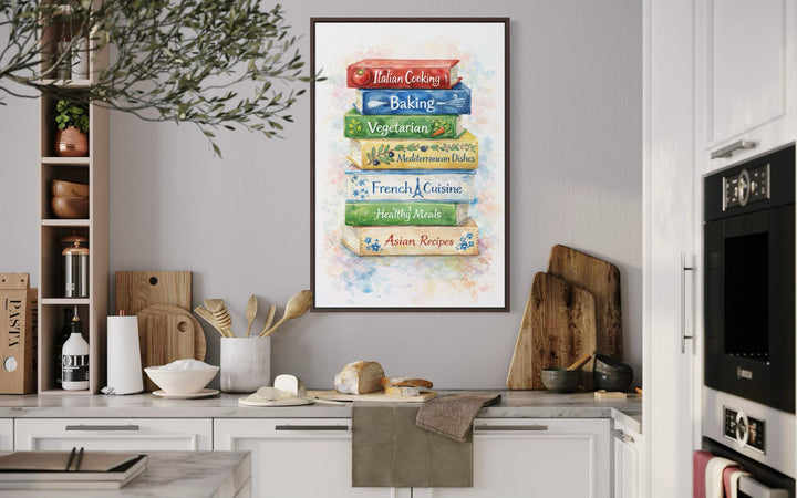 A vertical canvas print of stacked colorful cookbooks hangs on a gray wall in a farmhouse kitchen.
