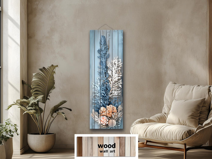 Narrow vertical wood wall art featuring a distressed coral print in blue, white, and beige tones.