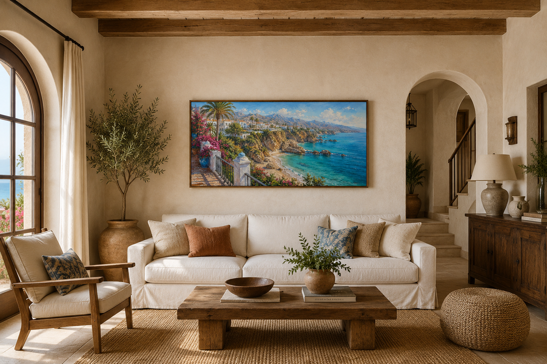 Framed canvas art of a Mediterranean coastal village above a white sofa in a rustic living room.