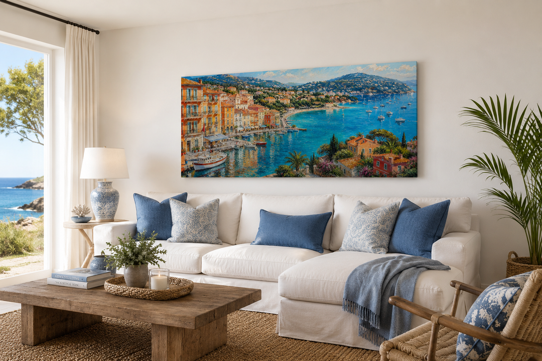 Cote d'Azur French Riviera harbor painting above a white sofa in a coastal living room.