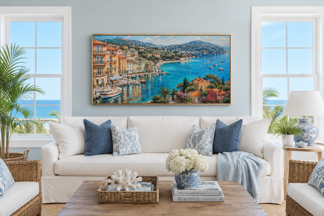 Cote d'Azur French Riviera coastal village harbor painting above a white sofa in a living room.