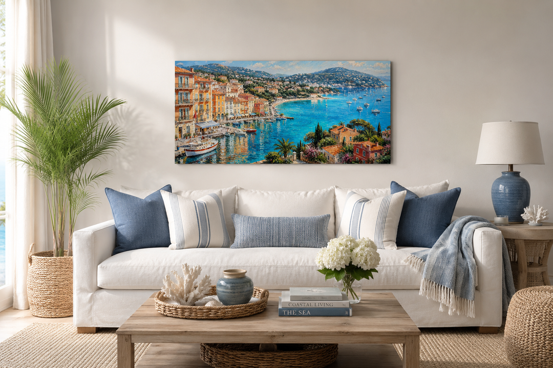 Cote d'Azur French Riviera harbor painting above a white sofa in a coastal-style living room.