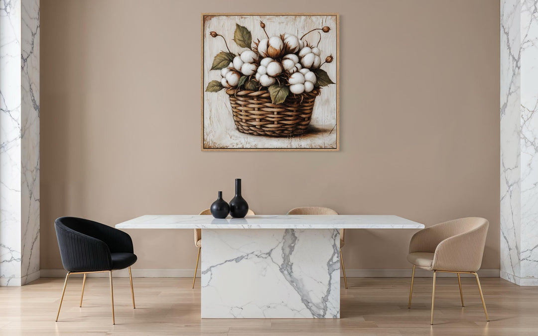 Cotton bolls in a wicker basket canvas wall art hanging above a modern marble dining table.