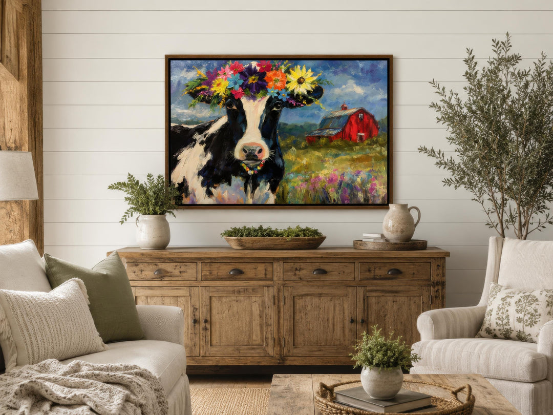 Whimsical canvas wall art of a cow with a flower crown in a rustic farmhouse living room.