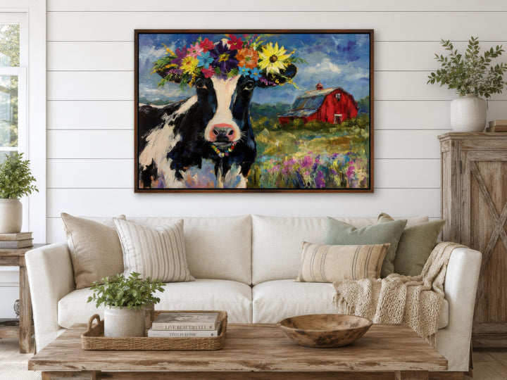 Whimsical canvas art of a cow with a flower crown in a farmhouse living room setting.