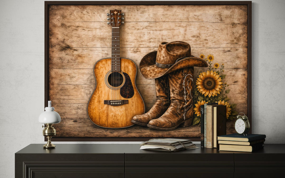 Rustic canvas wall art featuring a guitar, cowboy boots, hat, and sunflowers on a wooden background.