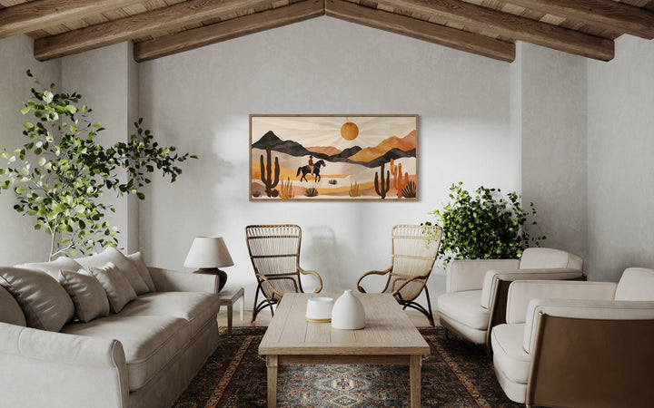 Cowboy in the desert framed canvas wall art in a neutral southwestern style living room.
