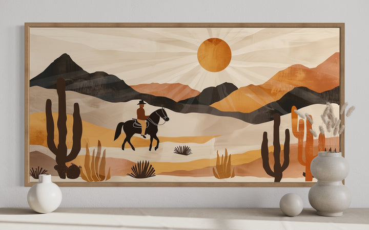 Cowboy in the desert framed canvas wall art with neutral southwestern mountains and cacti.