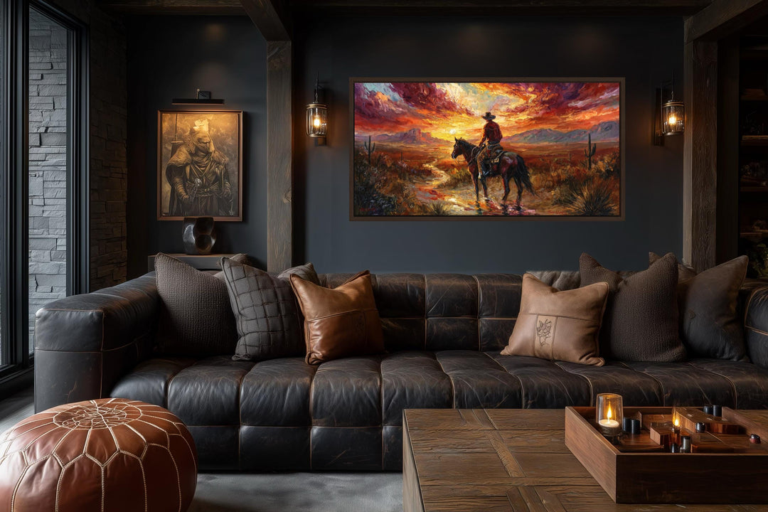 A wide canvas of a cowboy on horseback at sunset hangs in a rustic, dark-toned living room.