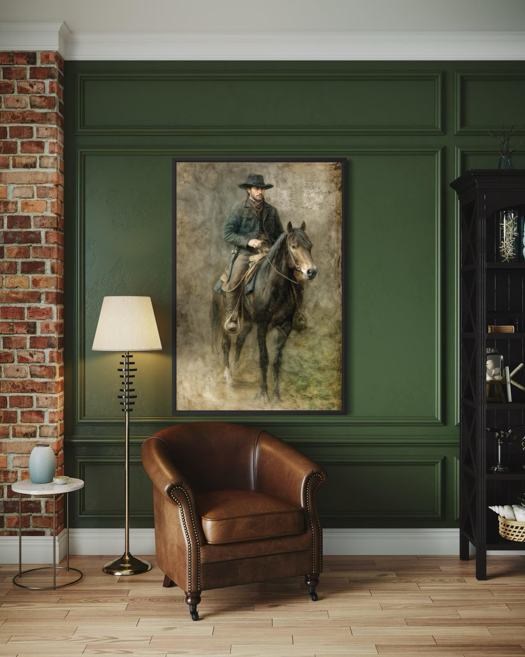 A framed vintage western canvas print of a cowboy on horseback hangs on a dark green paneled wall.