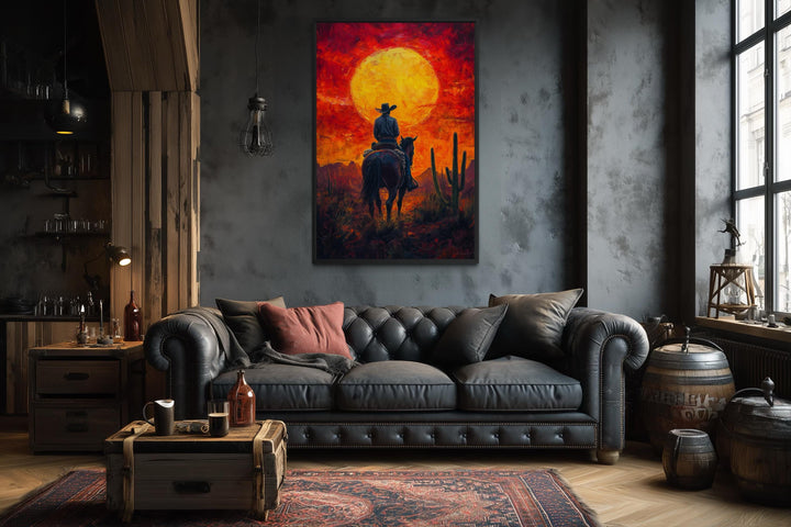 A framed canvas print of a cowboy on horseback silhouetted against a fiery desert sunset.
