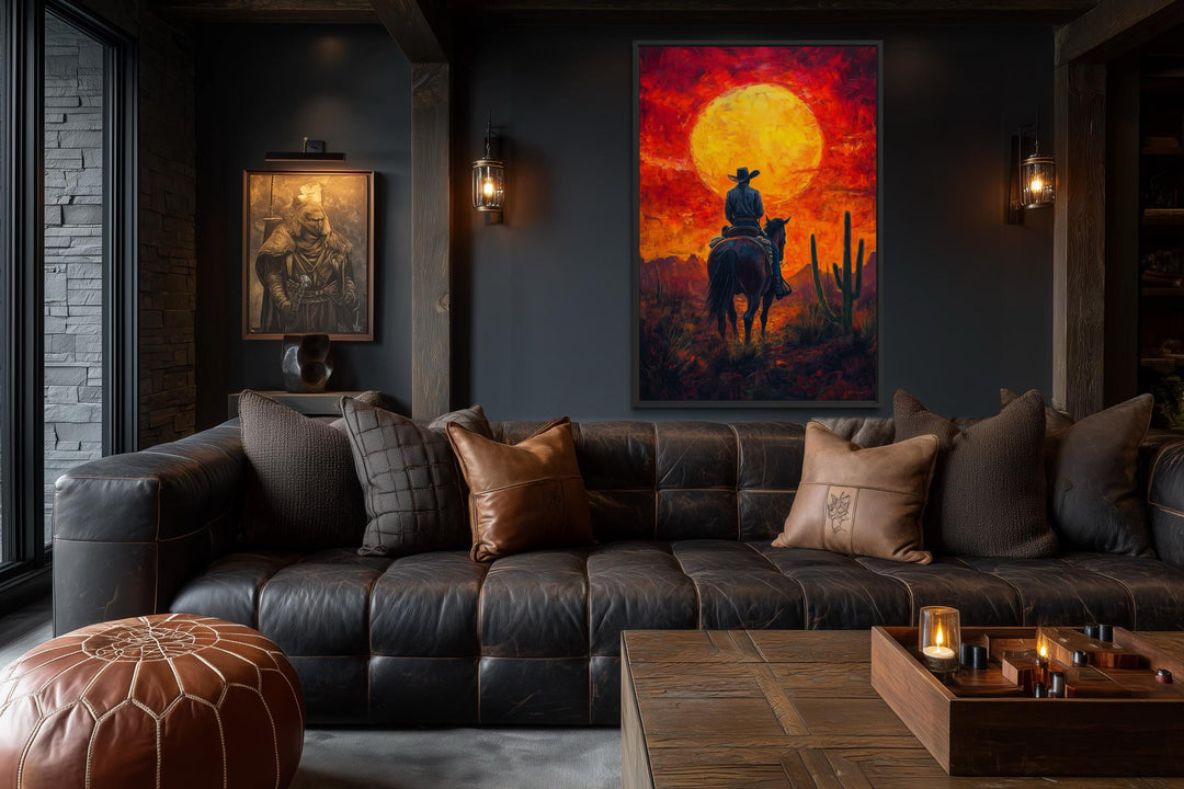 A framed canvas print of a cowboy on horseback silhouetted against a fiery orange desert sunset.