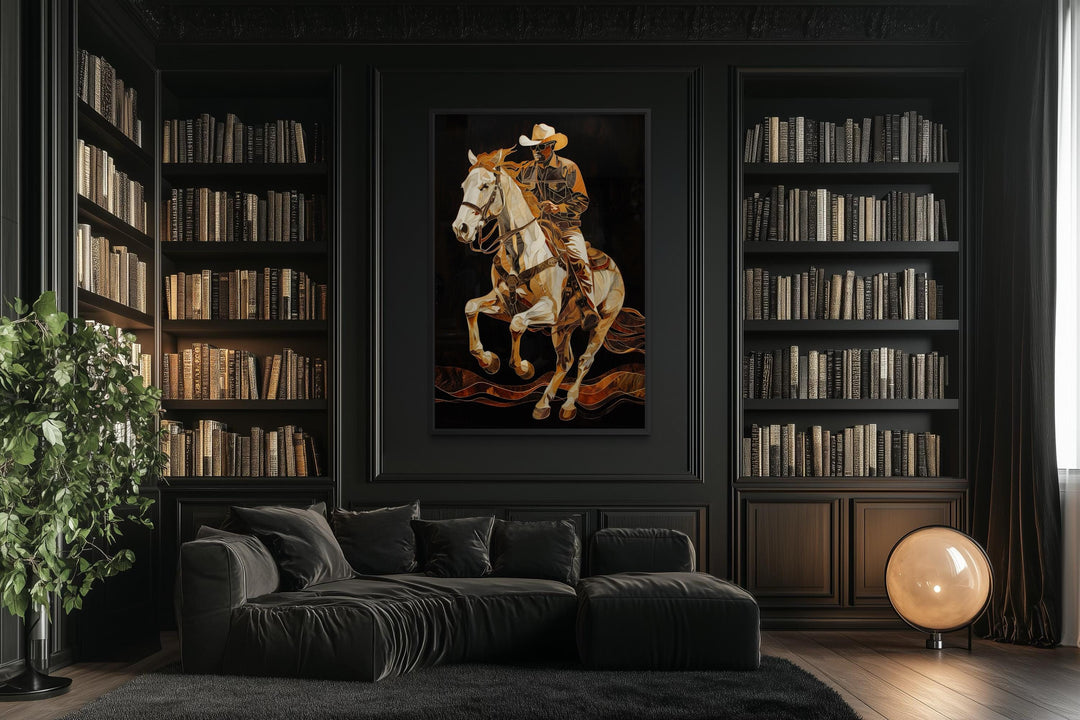 A vertical canvas painting of a cowboy on a horse in gold tones on a black library wall.