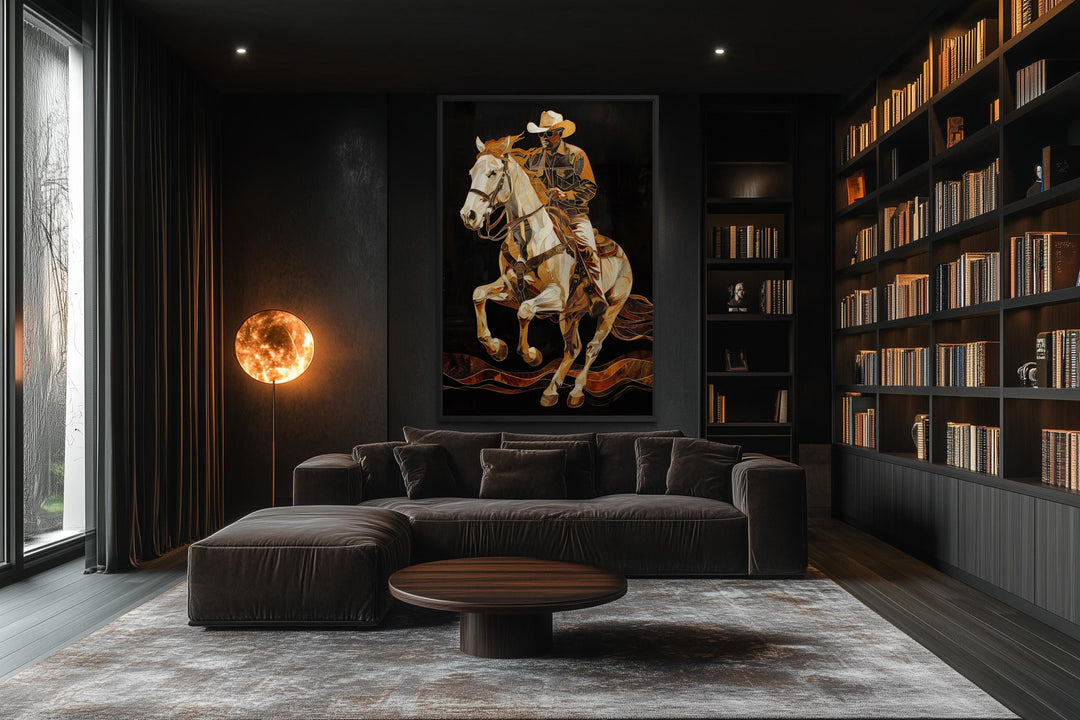 A vertical canvas painting of a cowboy on a horse in gold and bronze tones on a dark wall.