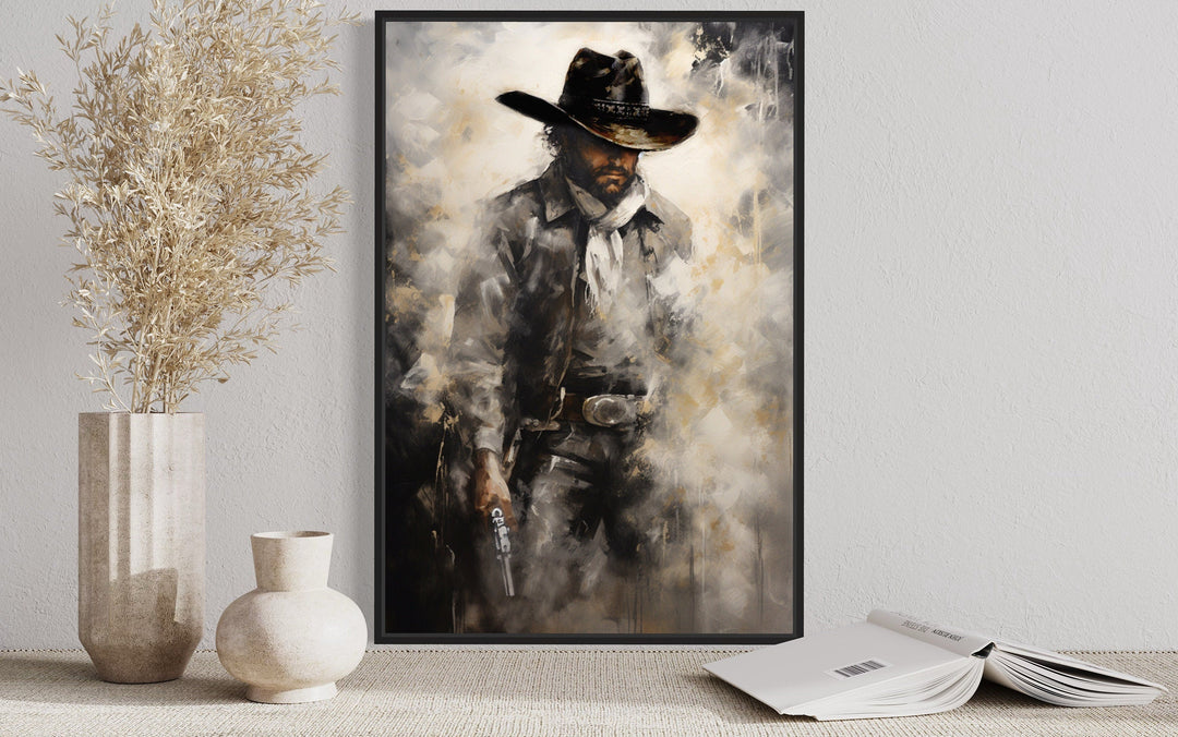 Framed canvas wall art of a cowboy holding a gun.