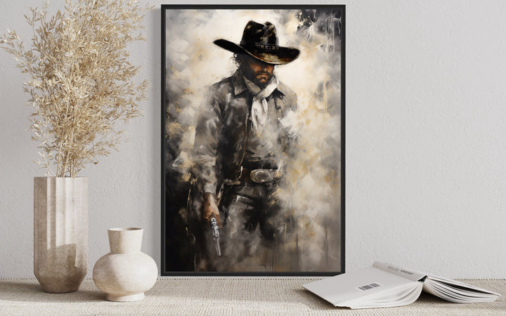 Framed canvas wall art of a cowboy holding a gun.