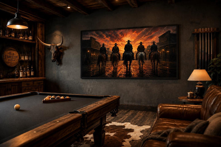 Cowboys riding into an Old West town at sunset canvas print in a rustic man cave with a pool table.