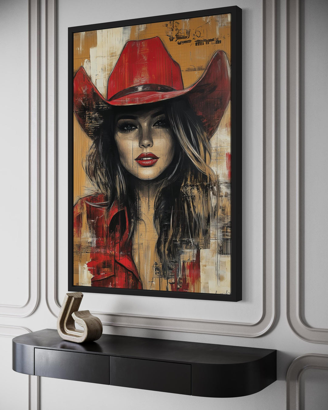 Framed graffiti-style canvas art of a cowgirl in a red hat above a black console table.
