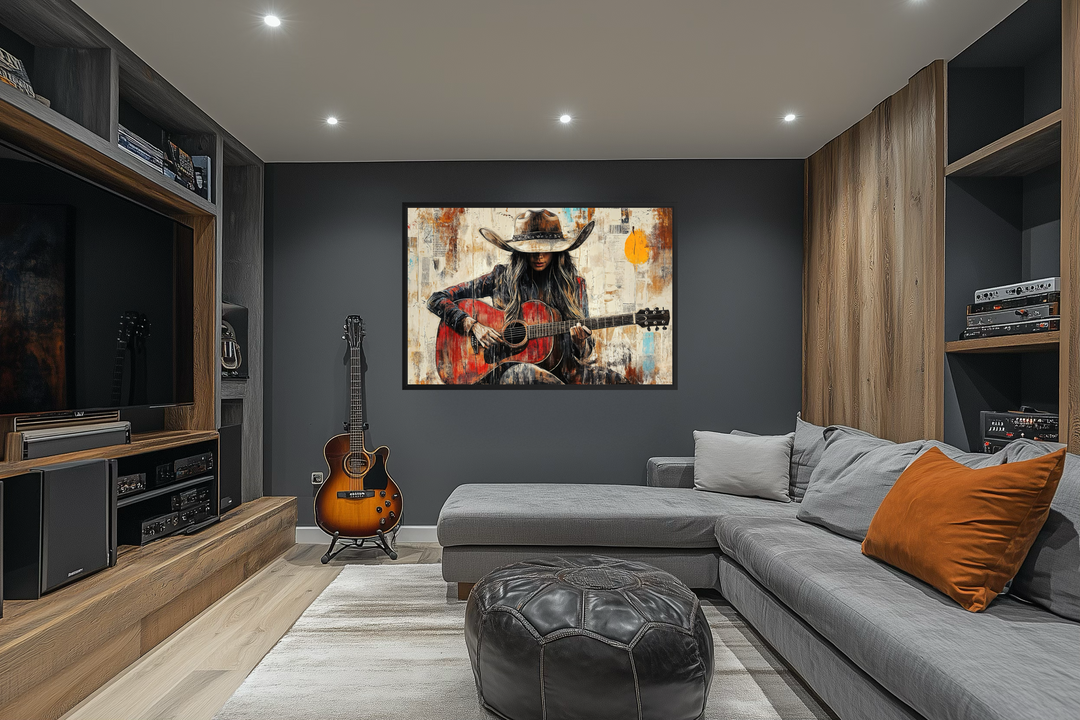 Framed canvas wall art of a cowgirl playing a red guitar in a rustic, painterly style.