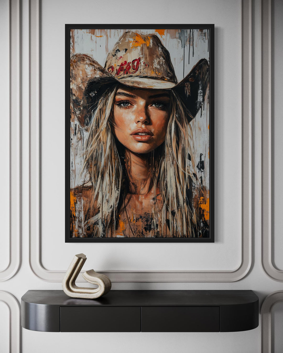 Cowgirl rustic graffiti portrait framed canvas wall art hanging above a dark console table.