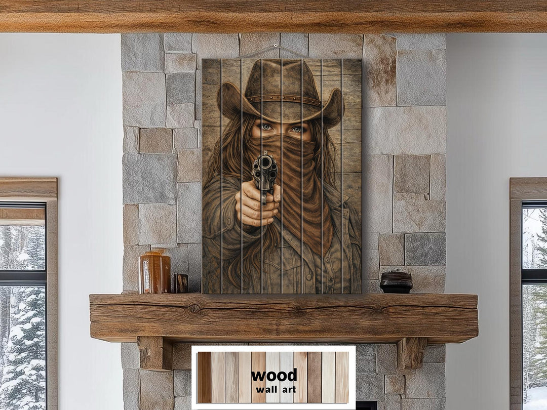 A rustic wood panel print of a masked cowgirl pointing a revolver, displayed above a fireplace.