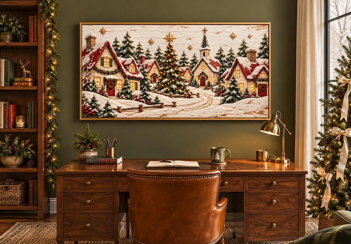 Cozy Christmas Village framed canvas wall art above a wooden desk in a festive home office.