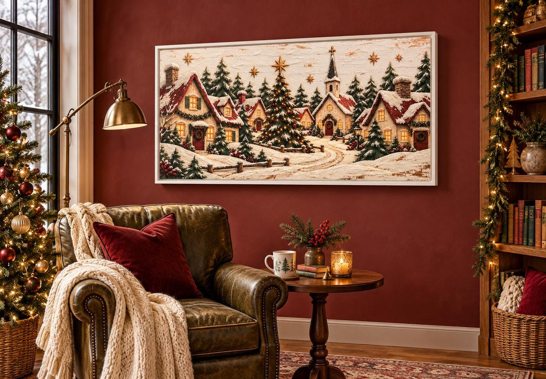 Cozy Christmas Village framed canvas wall art above a leather chair in a festive red room.