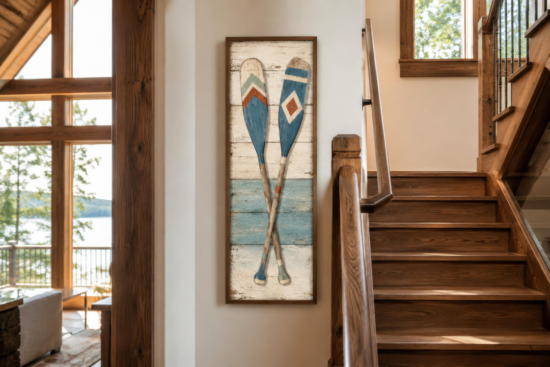 Tall narrow canvas wall art featuring two crossed rustic oars on a weathered wood-look background.