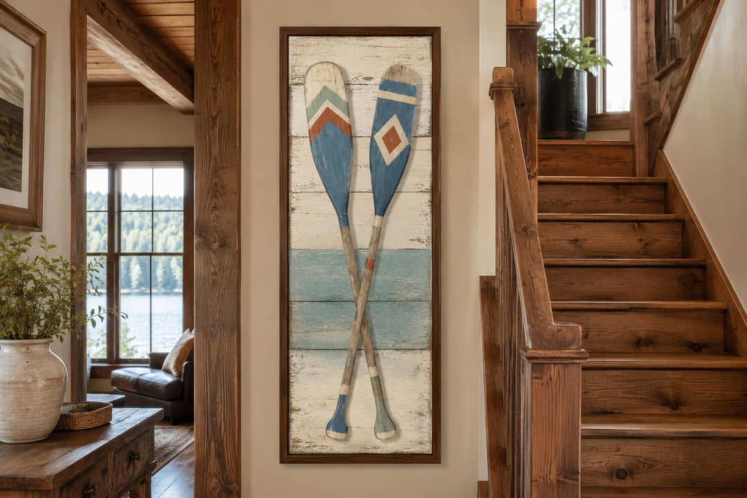 Rustic tall narrow canvas wall art featuring two crossed weathered wooden oars on a wood background.
