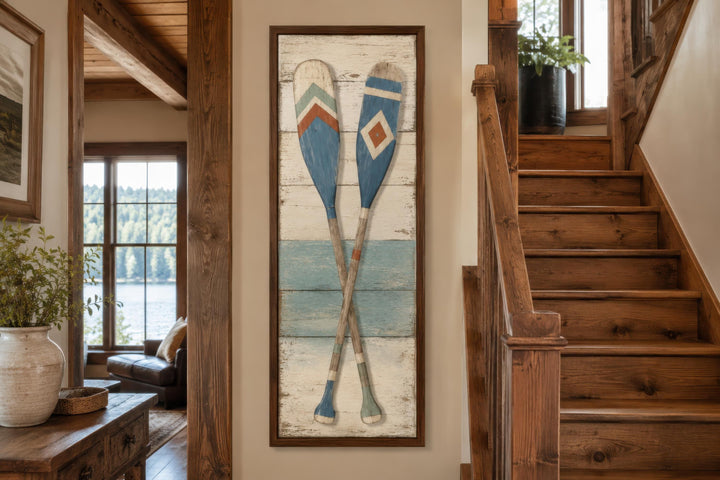 Rustic tall narrow canvas wall art featuring two crossed weathered wooden oars on a wood background.